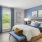 a bedroom with a bed and blue curtains