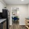 a kitchen with a fridge and dining table